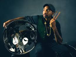 Jonathan Scales poses with one of his double seconds while holding a pair of mallets. 