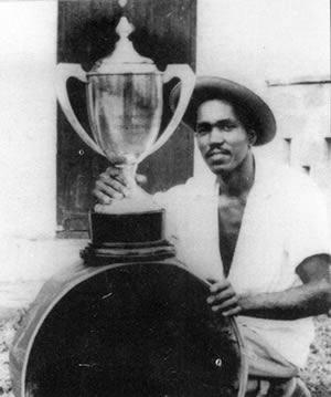 Tony Williams poses with his pan and a trophy he won. 